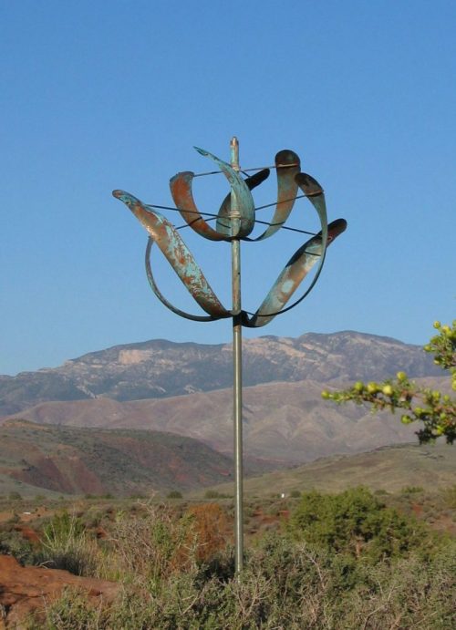 Windflower Wind Sculpture by Lyman Whitaker in a mountain setting.