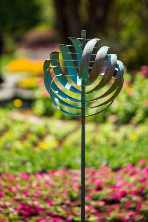 Nautilus wind sculpture in a garden environment.
