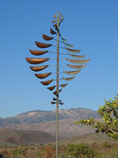 Double Helix Sail Wind Sculpture by Lyman Whitaker in a mountain setting.