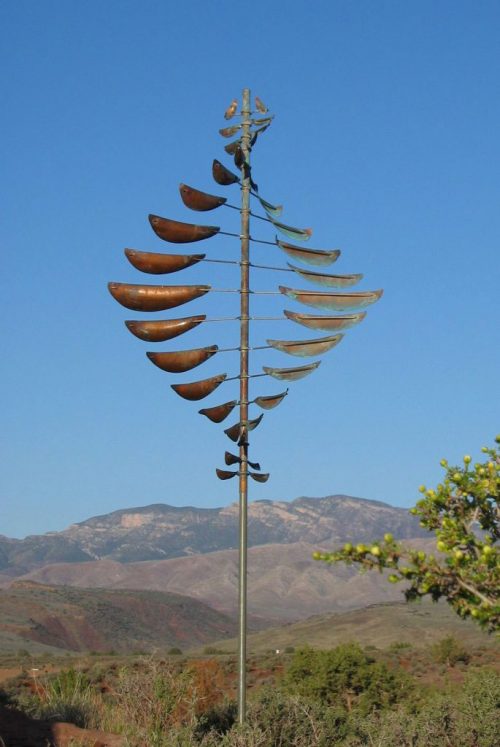 Double Helix Sail Wind Sculpture by Lyman Whitaker in a mountain setting.