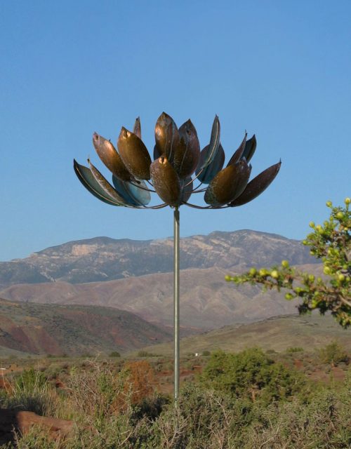 Lotus Wind Sculpture by Lyman Whitaker in a mountain setting.