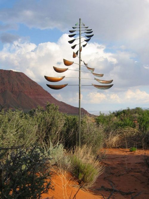 Sail Wind Sculpture by Lyman Whitaker in a desert setting.