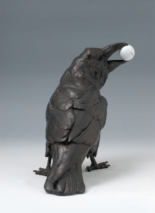 Bronze crow with a golf ball in its mouth by North Carolina wildlife sculptor Roger Martin.
