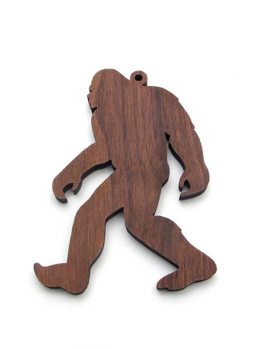 Handcrafted walnut sasquatch ornament by Nestled Pines woodworking.