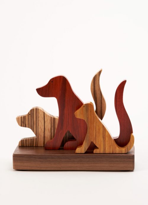Wooden sculpture of 3 dogs by artist Jerry Krider.