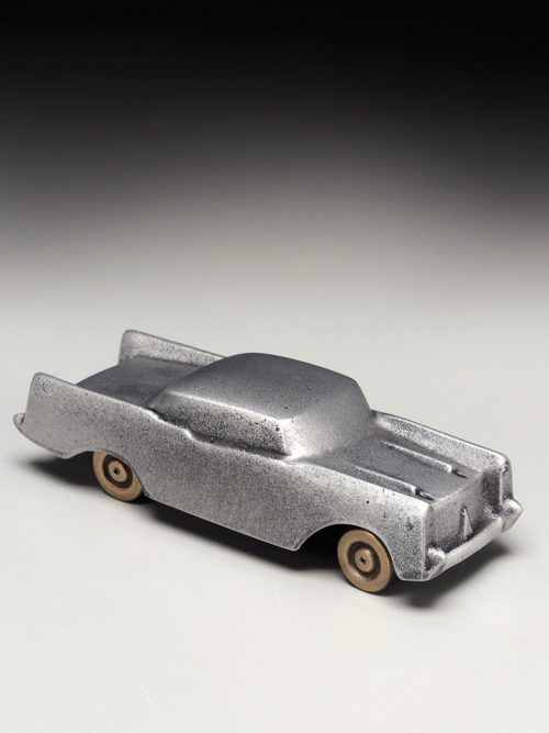 A small, metal sculpture of a 1957 Chevrolet handcrafted by Scott Nelles.