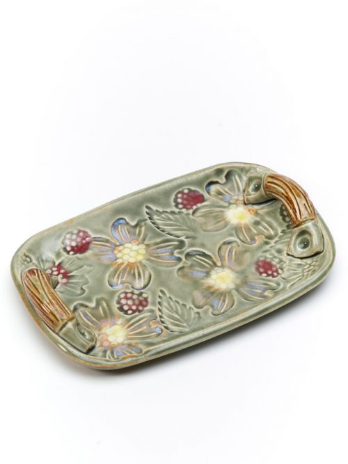 Handcrafted ceramic tray with a flower motif by North Carolina potter Vicki Gill.