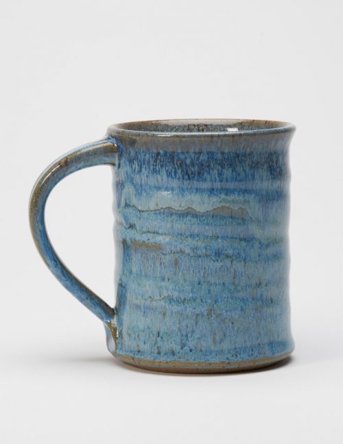 A stoneware mug with a blueberry glaze handmade by potter Steve Tubbs.