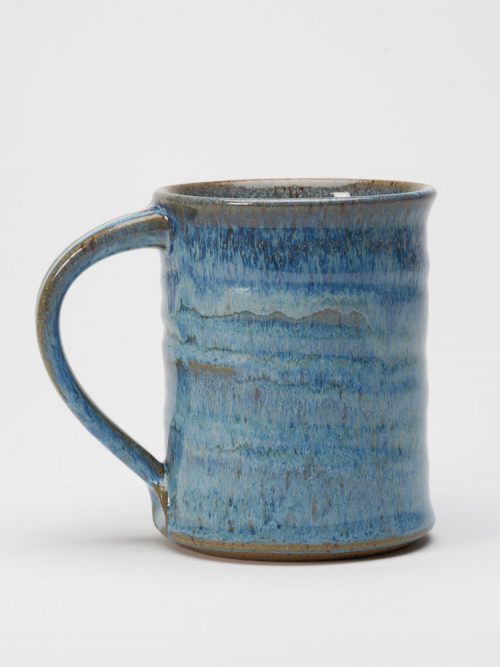 A stoneware mug with a blueberry glaze handmade by potter Steve Tubbs.
