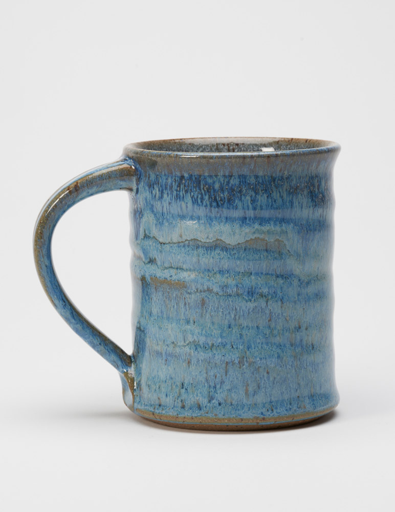 A stoneware mug with a blueberry glaze handmade by potter Steve Tubbs.