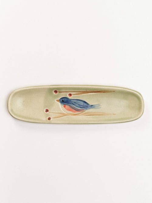 Handmade olive tray with a blue bird motif by North Carolina potter Vicki Gill.