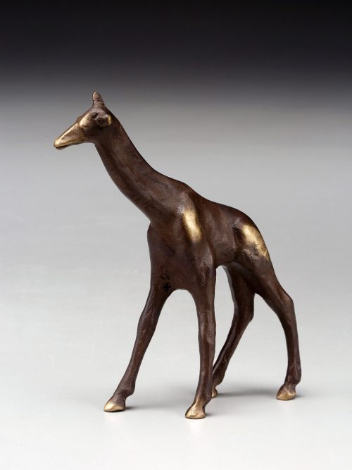 a small, cast bronze giraffe sculpture by artist Scott Nelles.