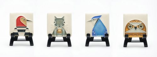 A grouping of four mini ceramic wildlife art tiles by Motawi Tileworks.