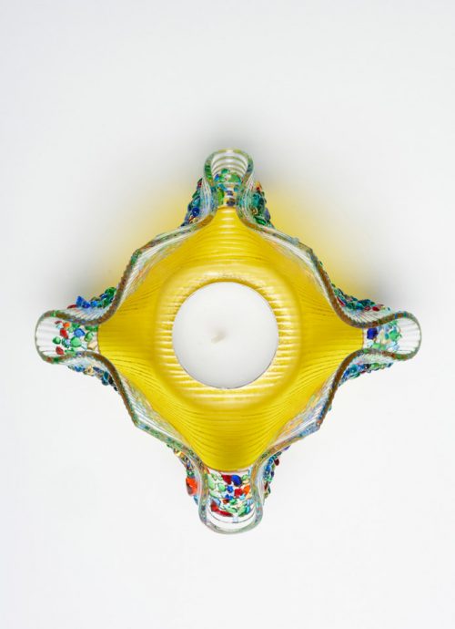 Top view of a yellow confetti glass votive by Jerry and Kathy Galloy.