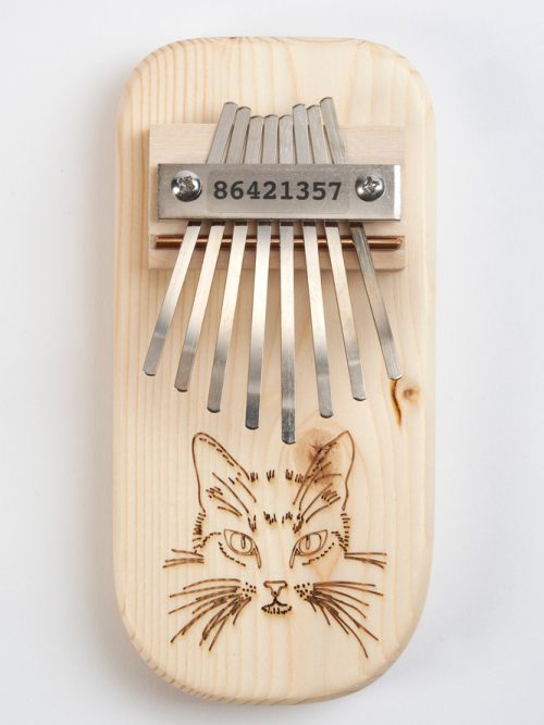 Wooden thumb piano with a cat design handmade by Paul and Sue Bergstrom.