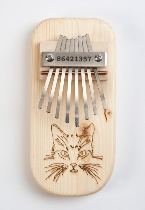 Wooden thumb piano with a cat design handmade by Paul and Sue Bergstrom.