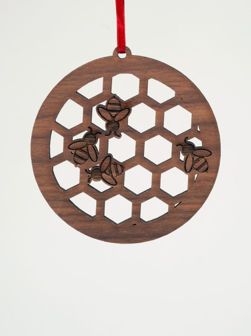 Handmade honeycomb ornament with bees by Nestled Pines Woodworking.