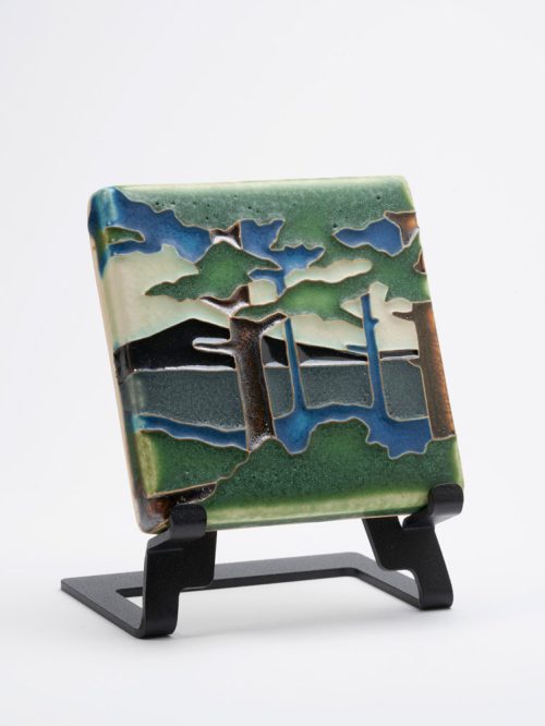Handmade ceramic art tile by Motawi Tileworks featuring a mountains and pine trees.