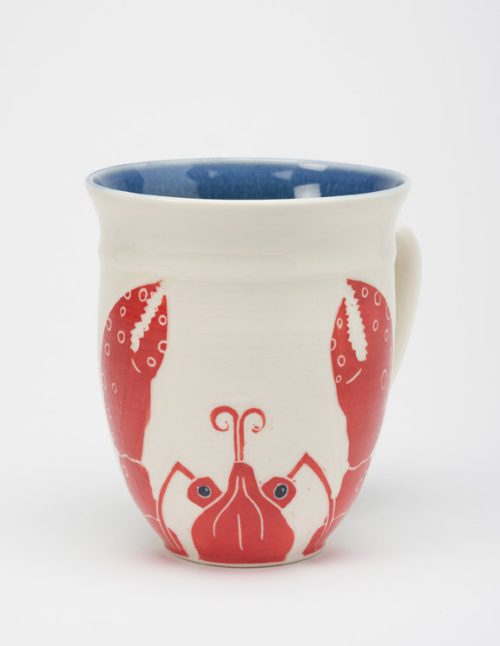 A porcelain coffee mug handmade by potter Anja Bartels, decorated with red lobster.