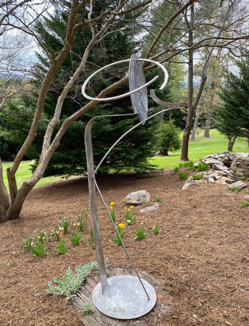 Stainless steel sculpture by artist Aldon Addington on display in a sculpture garden.