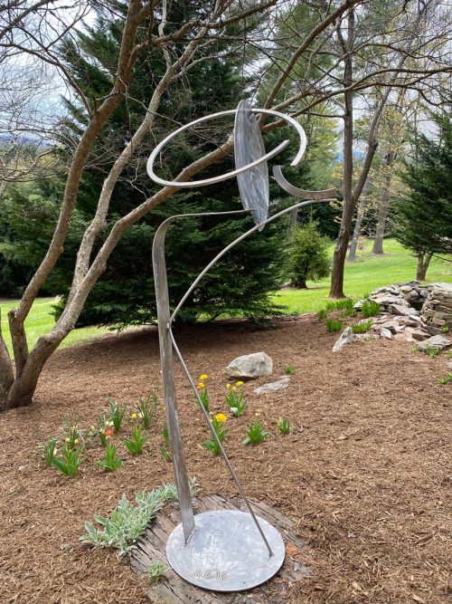 Stainless steel sculpture by artist Aldon Addington on display in a sculpture garden.