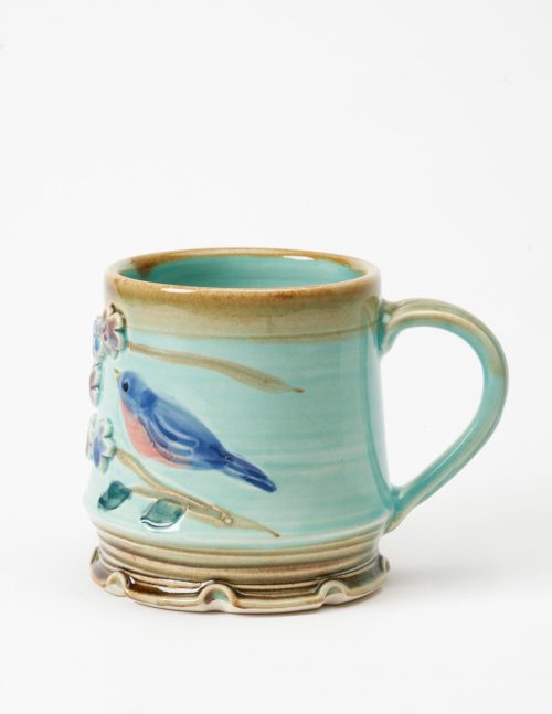 Handled ceramic mug with a bluebird motif by North Carolina studio potter Vicki Gill of Bluegill Pottery.