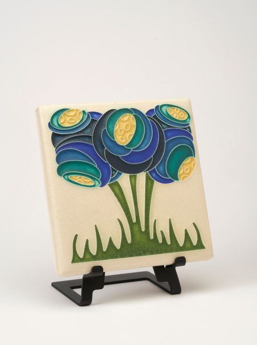 A handmade ceramic tile by Motawi Tileworks featuring a blue zoom blooms flower motif.