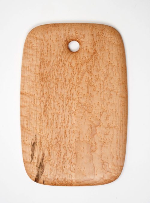 A birdseye maple breadboard handcrafted by Edward Wohl.
