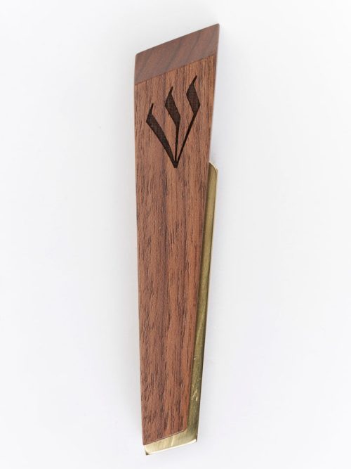 A Windthrow mezuzah case handcrafted from walnut and brass with a engraved shin.