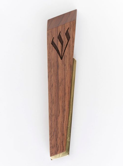 A Windthrow mezuzah case handcrafted from walnut and brass with a engraved shin.