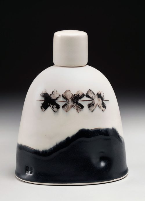 The backside of black and white porcelain karaoke bear flask by North Carolina studio potter Phil Haralam.