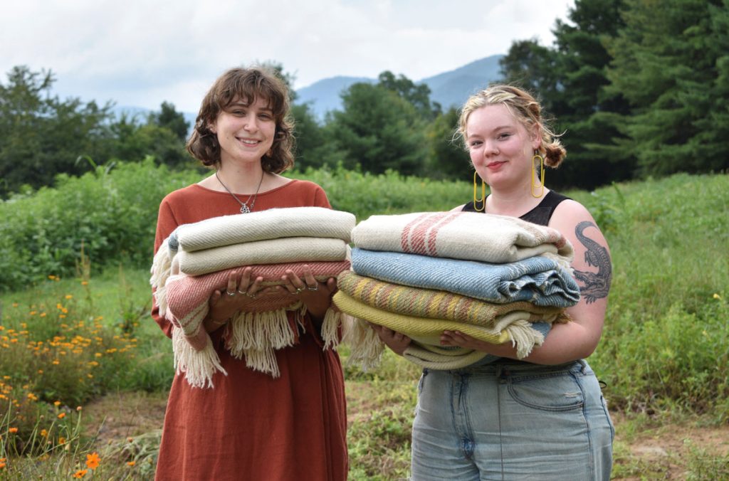 Weavers from Warren Wilson College holding the blankets they created for the Blue Ridge Blankets Project. Miles Klein (left) and Matilda Law (right). In the dye garden at Warren Wilson College, in Swannanoa, NC.