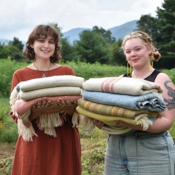 Weavers from Warren Wilson College holding the blankets they created for the Blue Ridge Blankets Project. Miles Klein (left) and Matilda Law (right). In the dye garden at Warren Wilson College, in Swannanoa, NC.