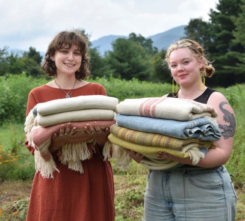 Weavers from Warren Wilson College holding the blankets they created for the Blue Ridge Blankets Project. Miles Klein (left) and Matilda Law (right). In the dye garden at Warren Wilson College, in Swannanoa, NC.