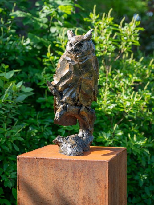 A bronze owl sculpture by Roger Martin titled Moonshadow.