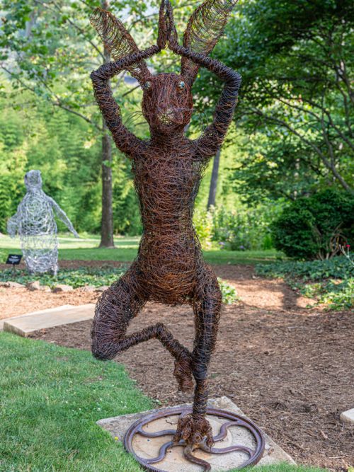 Garden art - a wire hare sculpture doing a yoga pose.