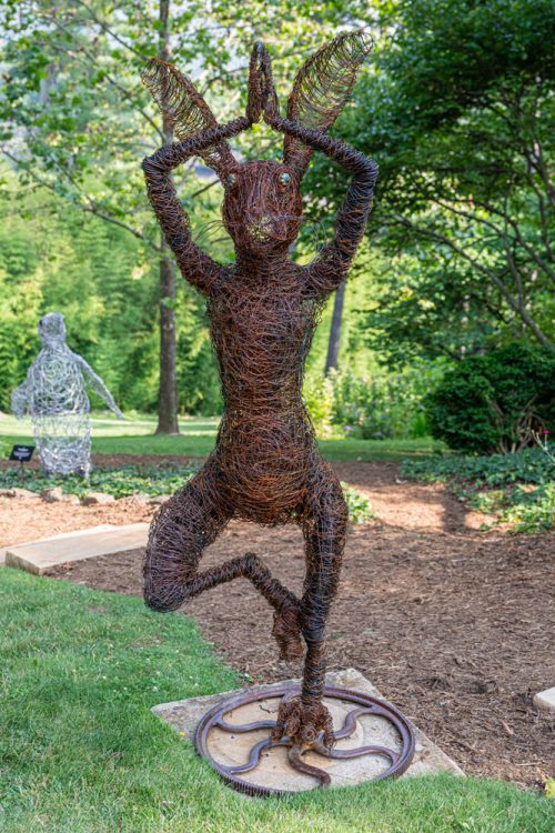 Garden art - a wire hare sculpture doing a yoga pose.