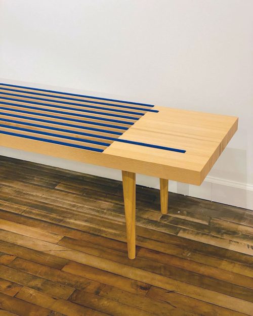 Detail of an ash bench with blue wool felt by Libby Schrum.