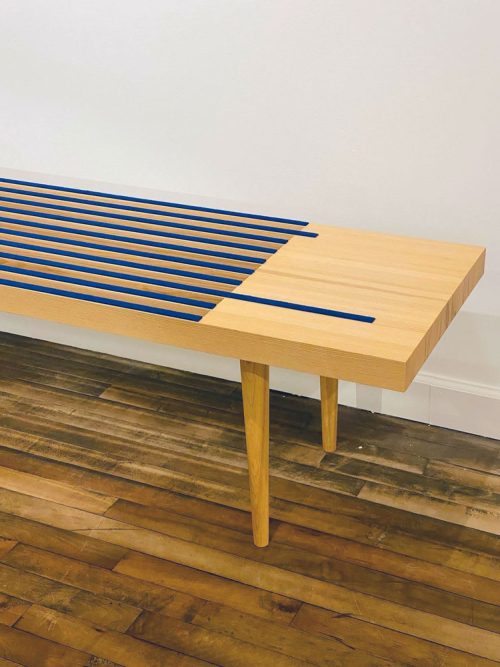 Detail of an ash bench with blue wool felt by Libby Schrum.