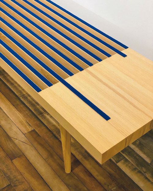 Detail of an ash bench with blue wool felt by Libby Schrum.