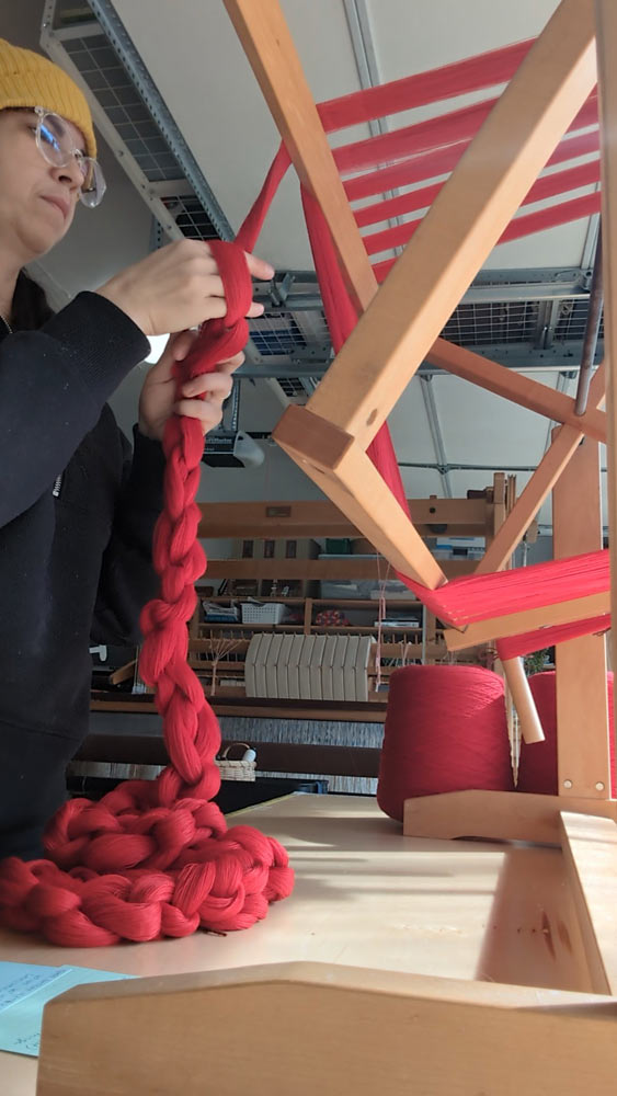 Deanna Lynch in her home studio prepping the warp for weaving.