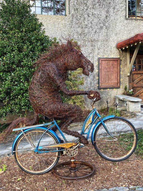 Wire horse sculpture on a vintage bicycle by Josh Cote.