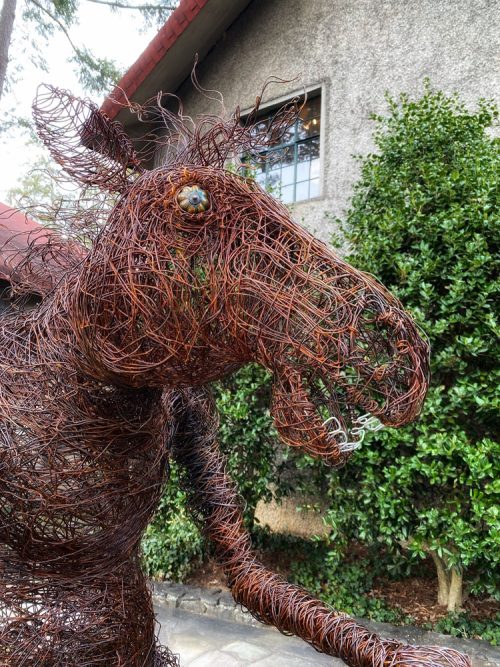 Detail of a wire horse sculpture.