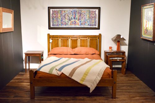 The Asheville Blanket by Local Cloth draped on a bed.