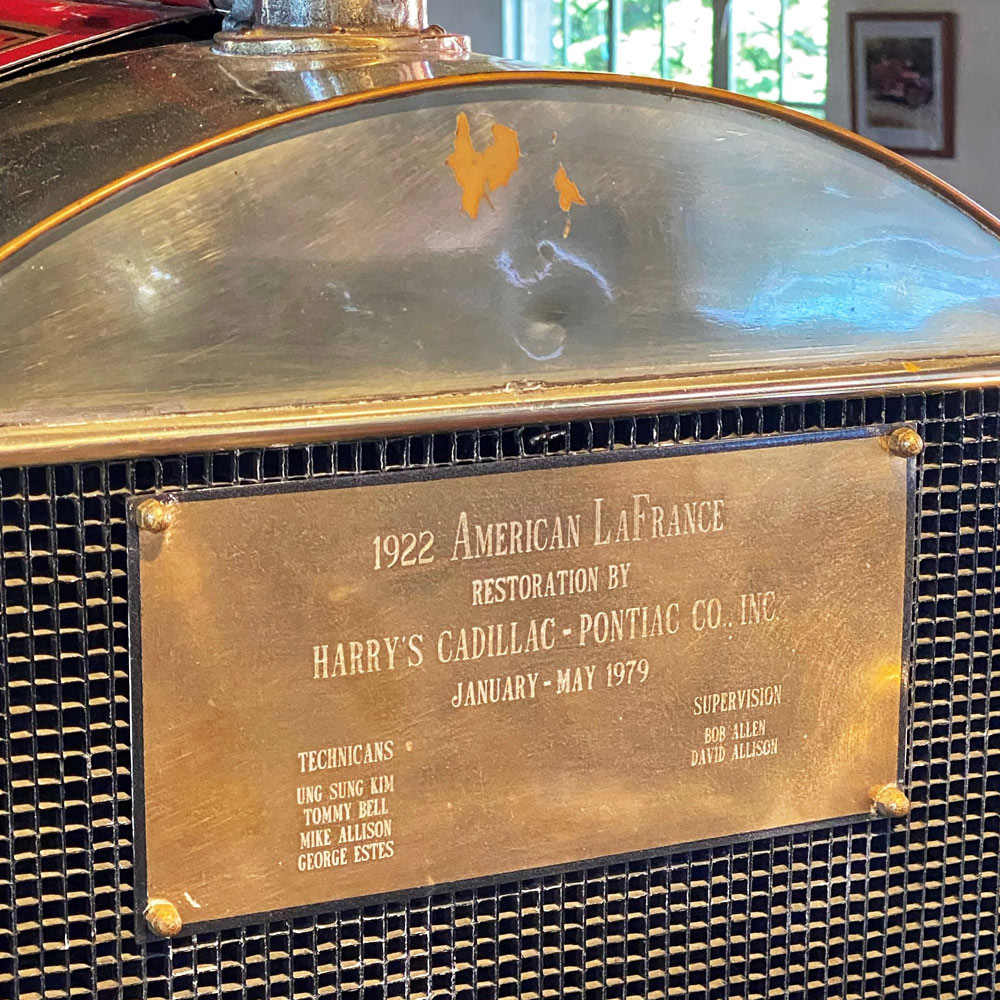A brass plaque commemorating the technicians and supervisors of the 1979 restoration is on the front of the fire engine.