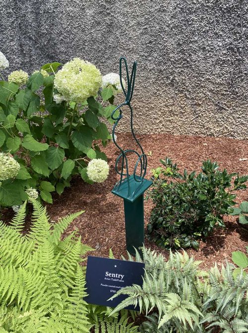 A powder coated steel rabbit outdoor sculpture by Todd Frahm titled Sentry.