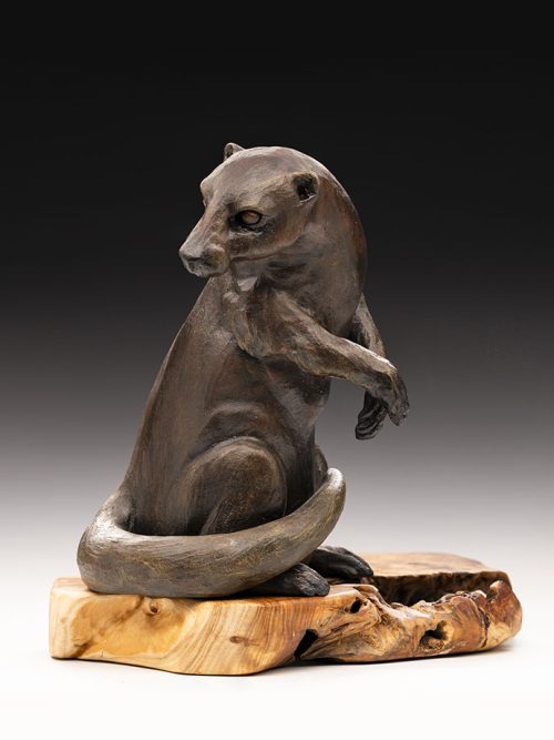 Otter sculpture on wood base by artist Tina Curry.