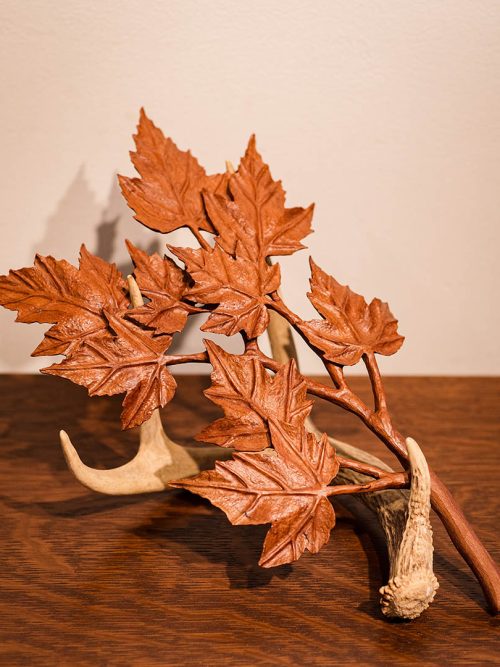 Antler with mple branch by Joel Rakower.