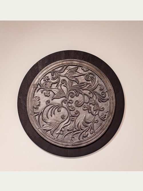 A botancial carved wall piece by artist Leslie Green Guilbault.