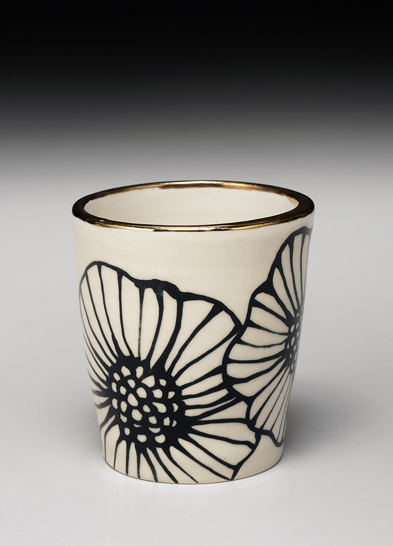 A stoneware floral tumbler by Nicole Hsieh.